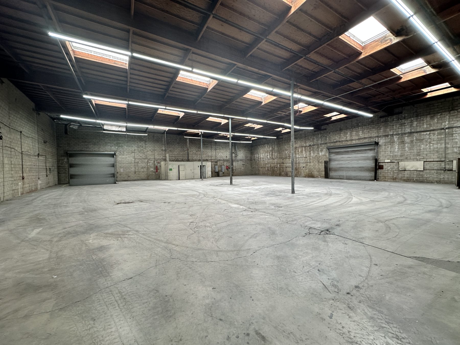 Open warehouse — wood trusses, skylights, new LED lighting